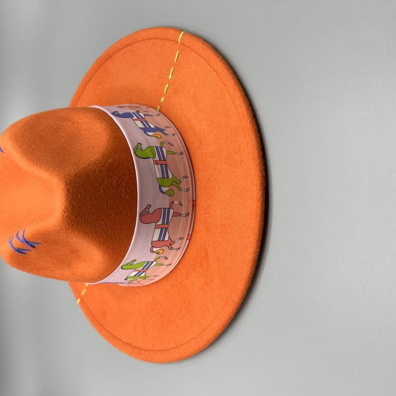 Orange fedora with yellow and blue stitches