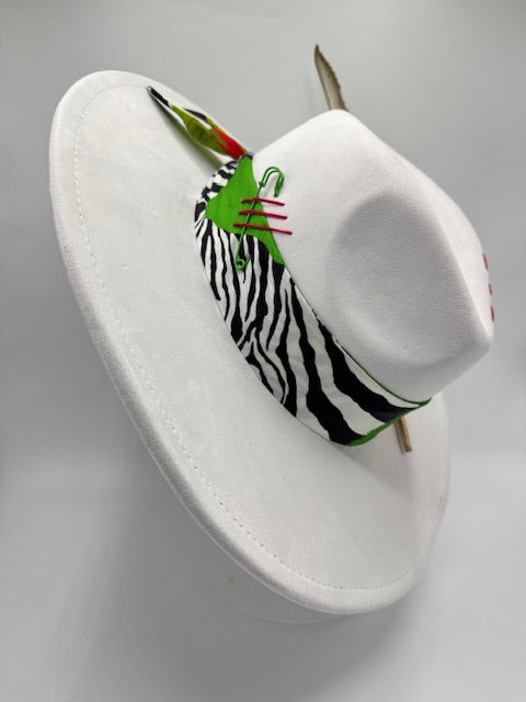 Wide brim white Fedora with colorful scarf and gold feather