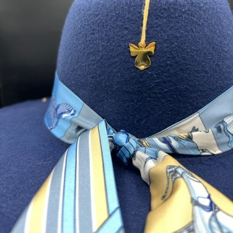 Navy blue fedora with angel accessory