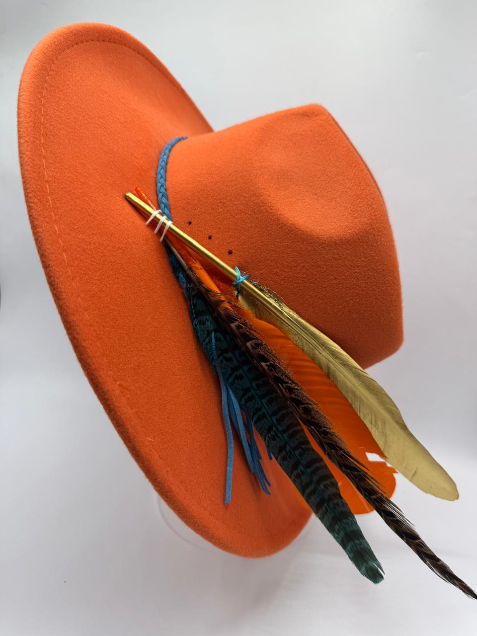 Orange wide brim fedora with blue details and feathers