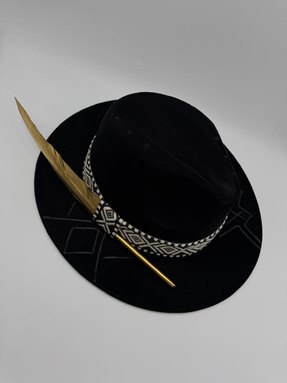 Black suede fedora with hand carving and gold feather