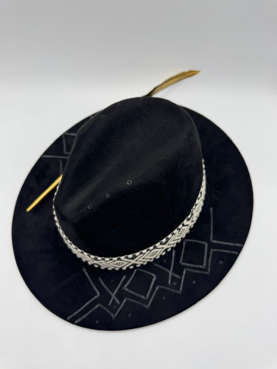 Black suede fedora with hand carving and gold feather