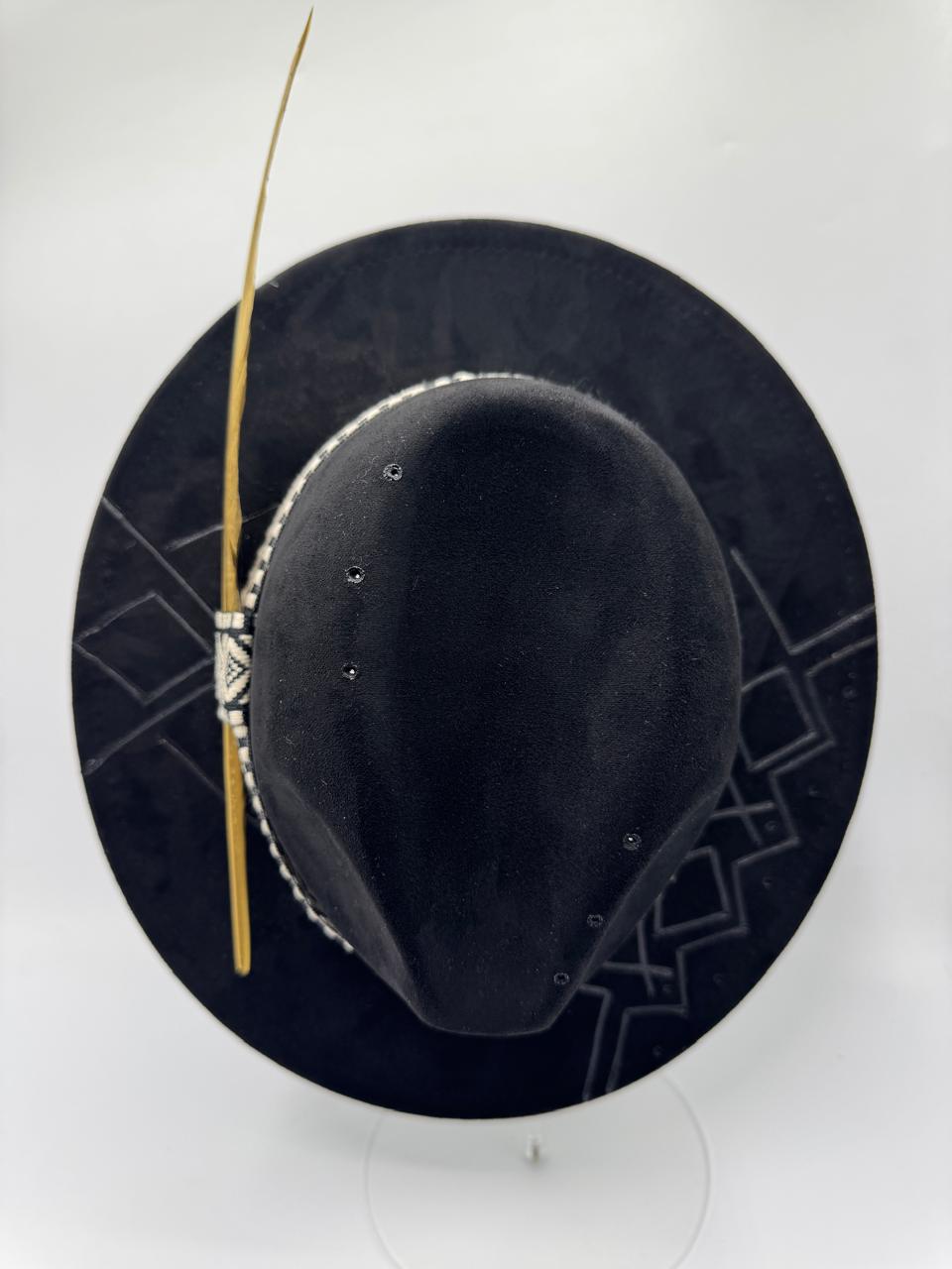 Black suede fedora with hand carving and gold feather