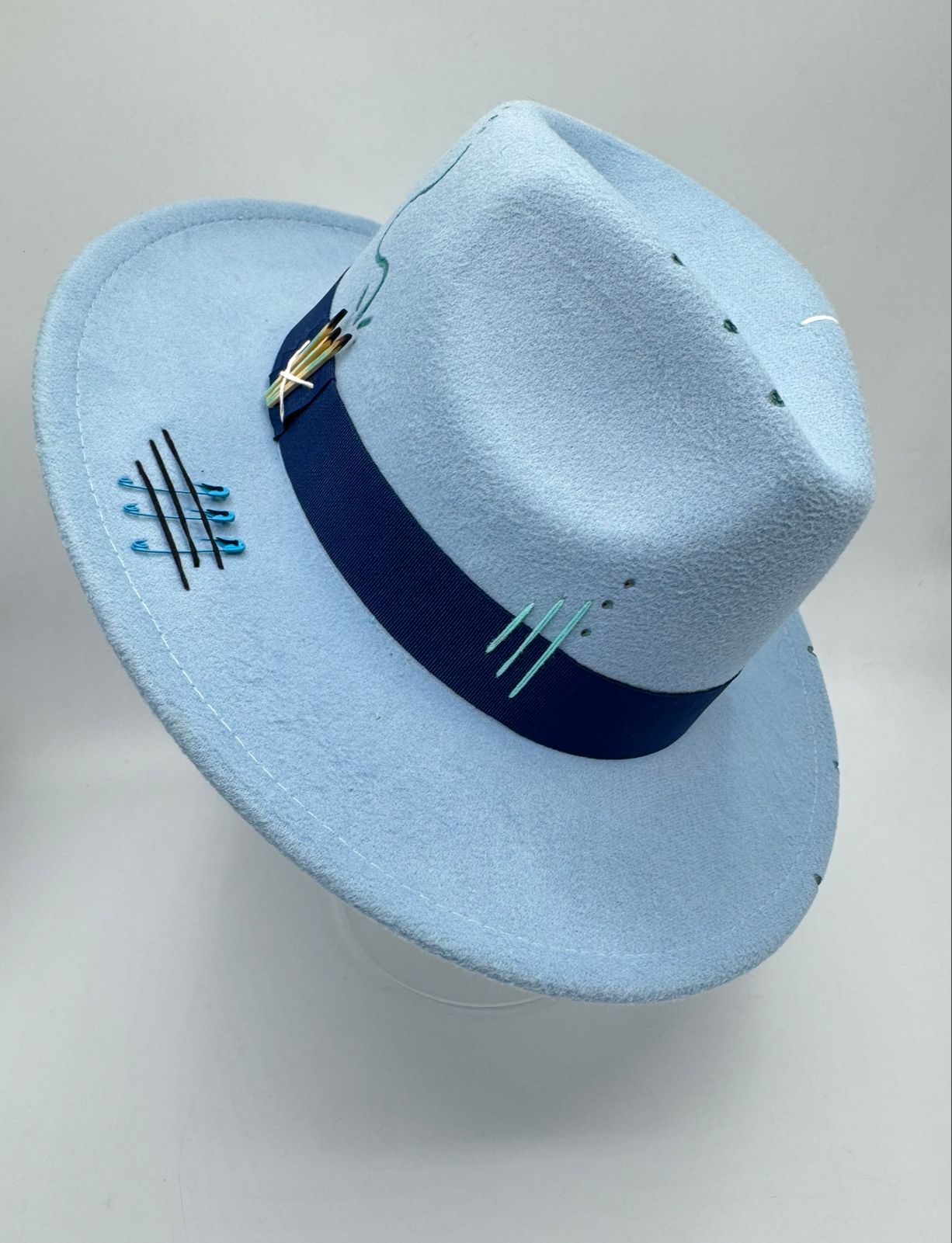 Baby blue fedora with cards and feathers