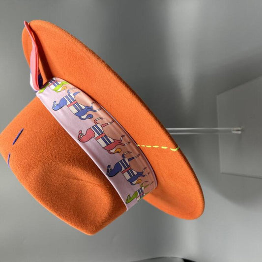 Orange fedora with yellow and blue stitches