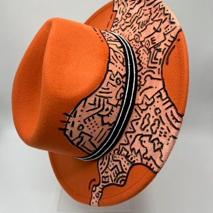 Orange fedora with hand drawing