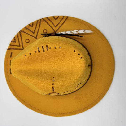 Mustard fedora with carving and feather