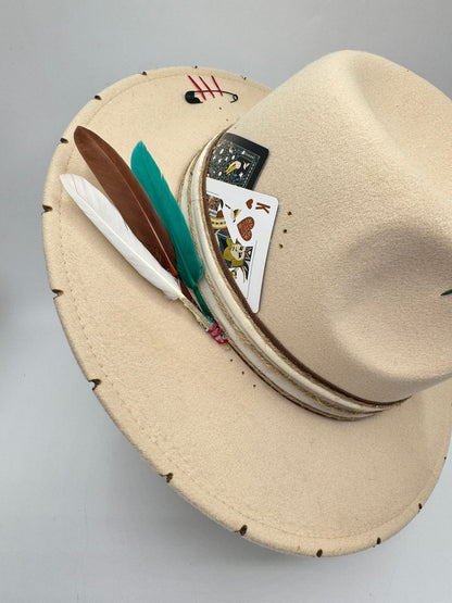 Beige fedora with cards and feathers