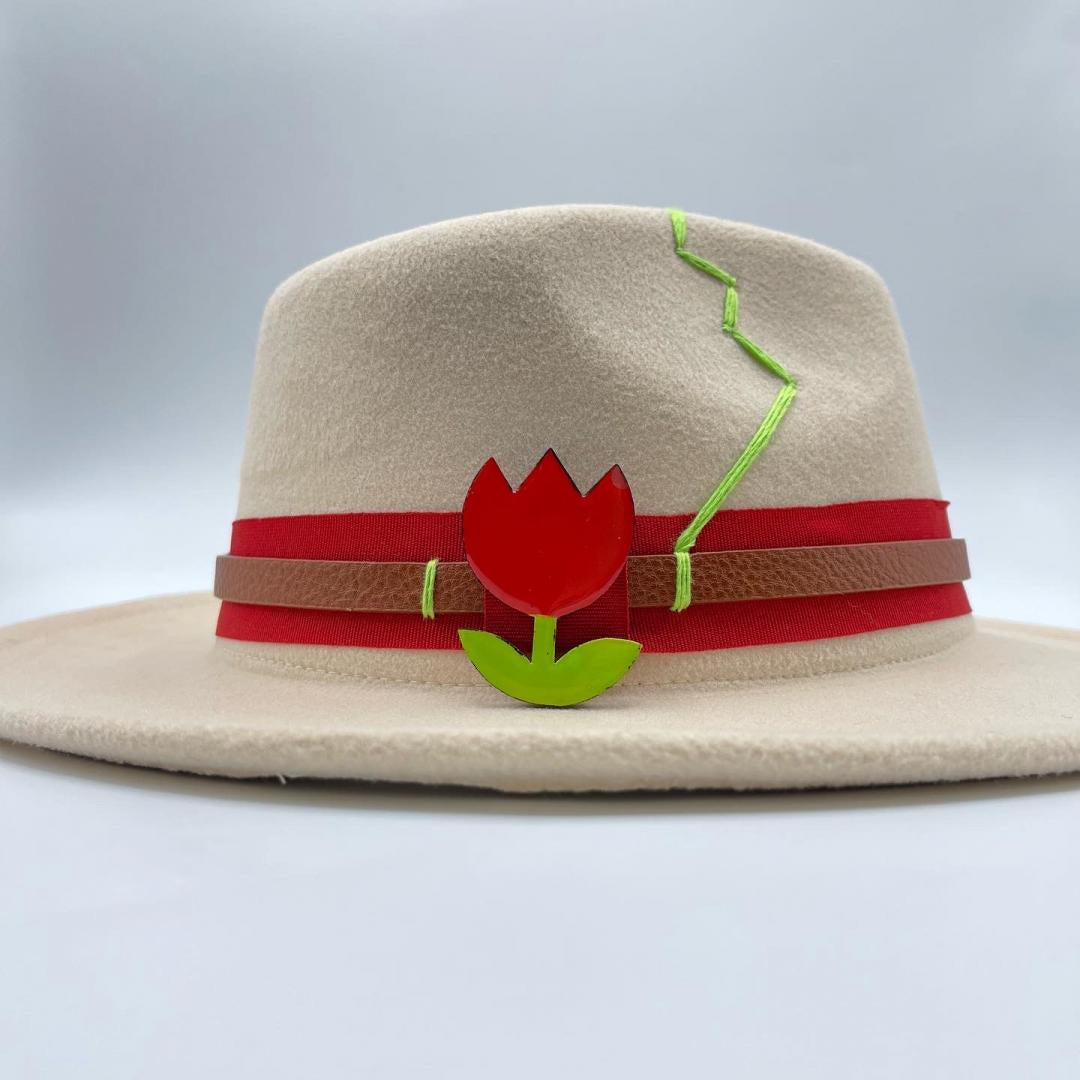 Beige fedora accessorized with tulip brooch