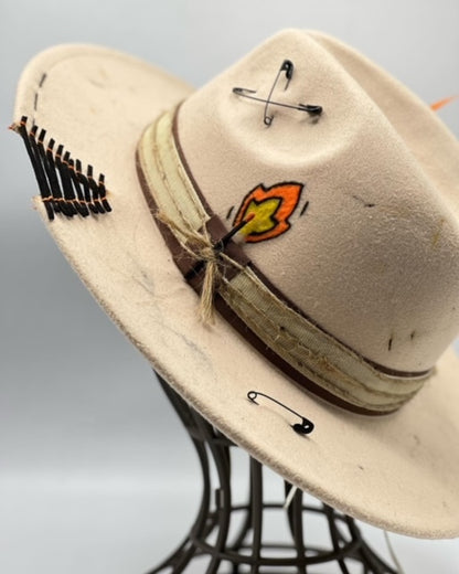 Beige fedora with golden card and golden feather