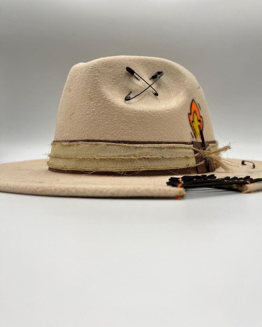 Beige fedora with golden card and golden feather