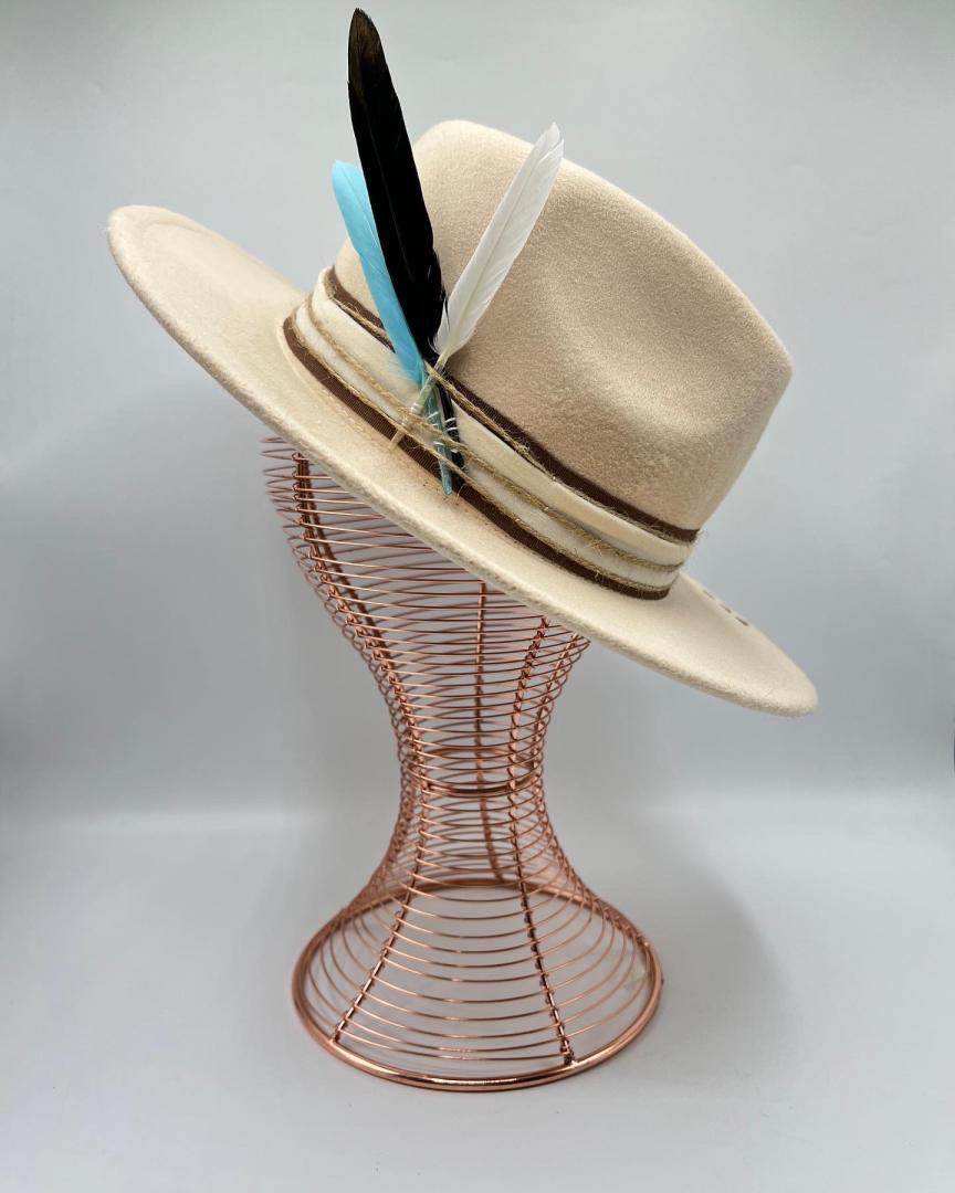 Beige hat with turquoise  feather