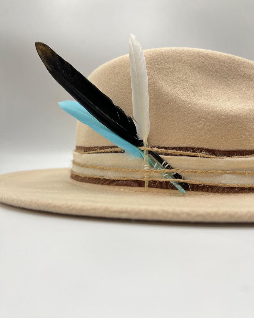 Beige hat with turquoise  feather