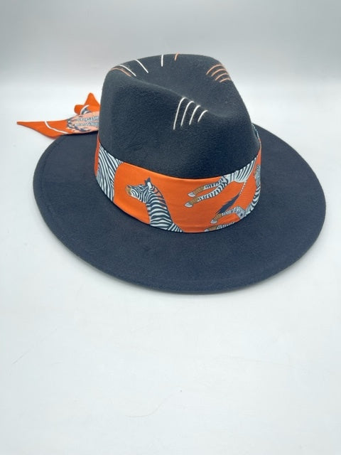 Black fedora with orange scarf