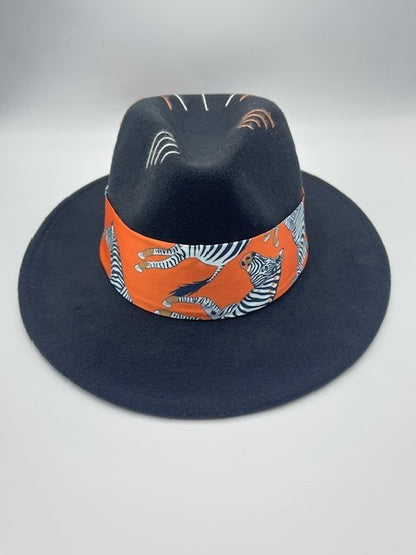 Black fedora with orange scarf