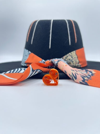 Black fedora with orange scarf