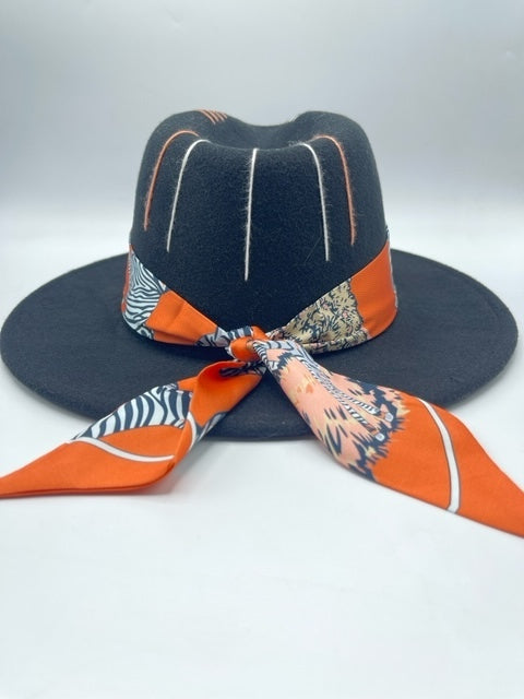 Black fedora with orange scarf