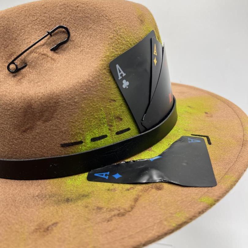 Brown fedora with green shades and black playing cards