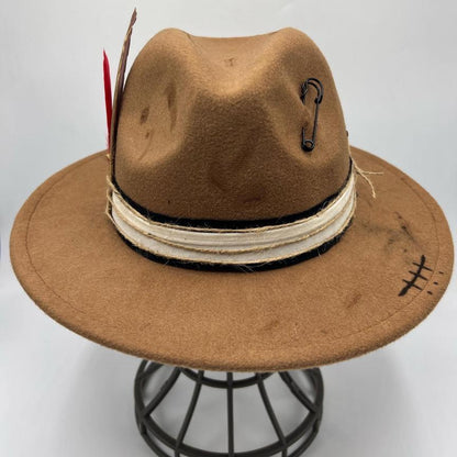 Brown fedora with red feather and gold card