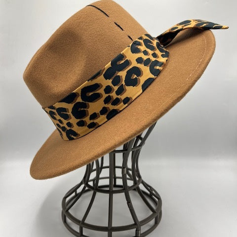 Brown fedora with tiger print scarf