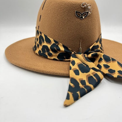 Brown fedora with tiger print scarf