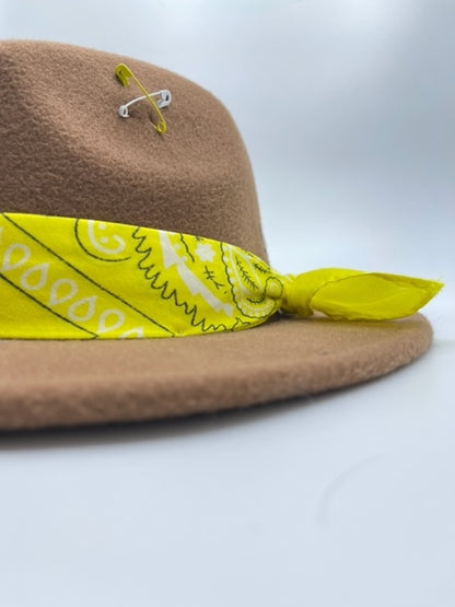 Brown fedora with yellow scarf