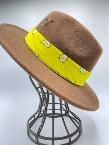 Brown fedora with yellow scarf