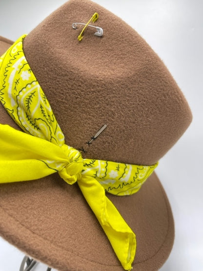 Brown fedora with yellow scarf