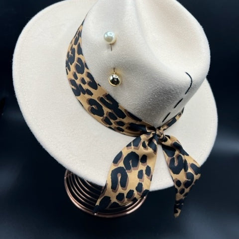 Elegant beige fedora with tiger print and pearl brooch