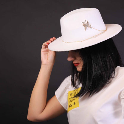 Fedora accessorized with airplane and pearls