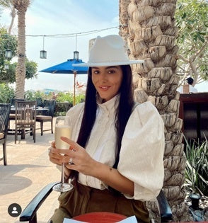 Fedora accessorized with airplane and pearls