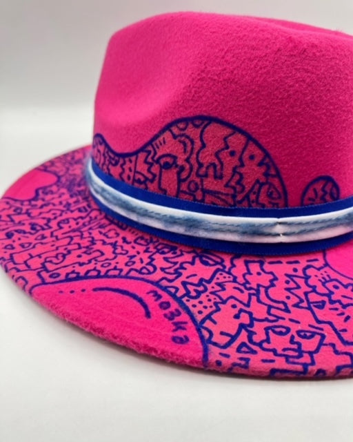 Fuchsia fedora with blue hand drawing