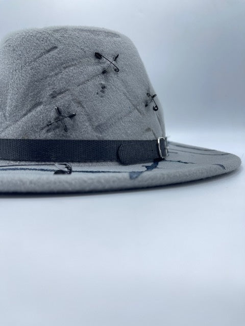 Grey fedora with safety pins