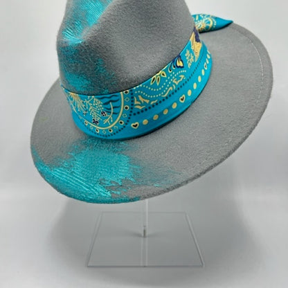 Grey fedora with turquoise scarf and hand drawing