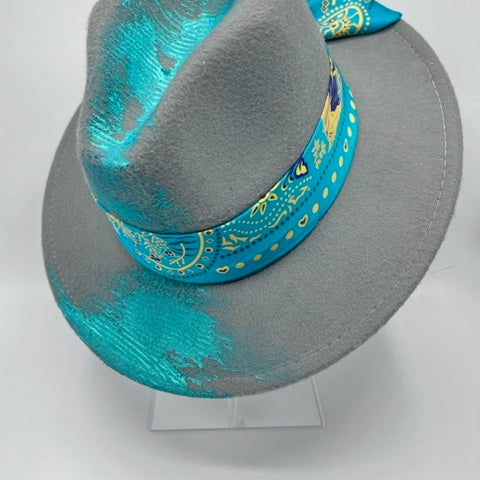 Grey fedora with turquoise scarf and hand drawing