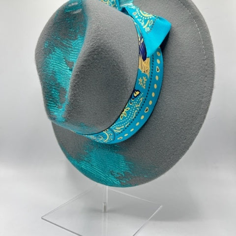 Grey fedora with turquoise scarf and hand drawing