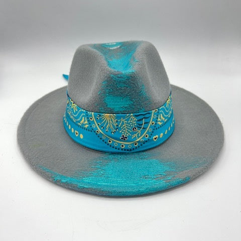 Grey fedora with turquoise scarf and hand drawing