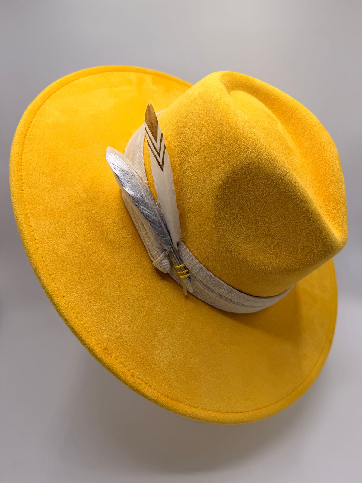 Yellow wide brim fedora with feathers