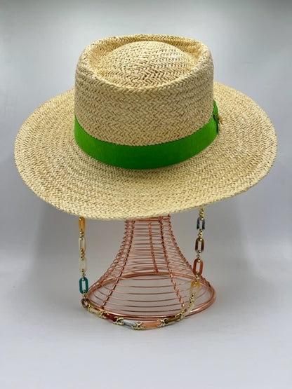 Straw summer hat with green band and airplane accessory