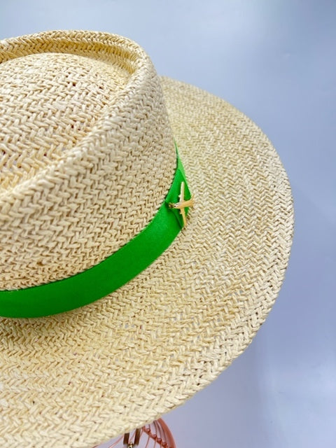 Straw summer hat with green band and airplane accessory