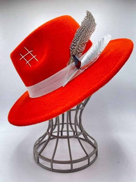 Vibrant red fedora with white band and feathers