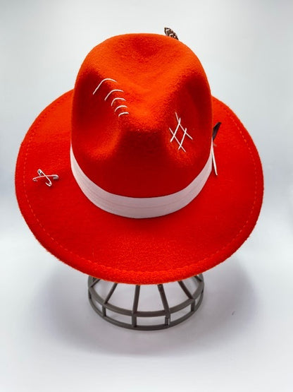 Vibrant red fedora with white band and feathers