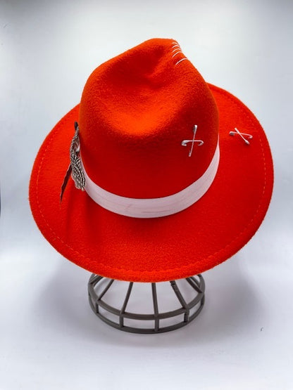 Vibrant red fedora with white band and feathers