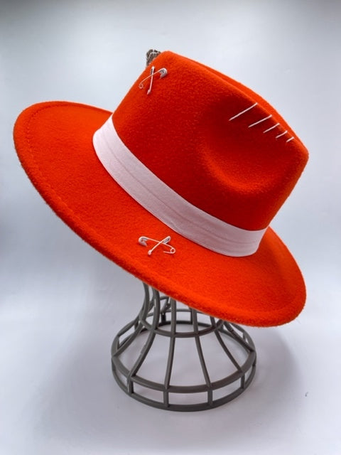 Vibrant red fedora with white band and feathers