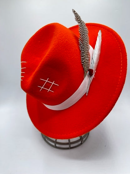 Vibrant red fedora with white band and feathers