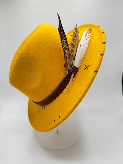 Yellow mustard fedora with feathers and carving